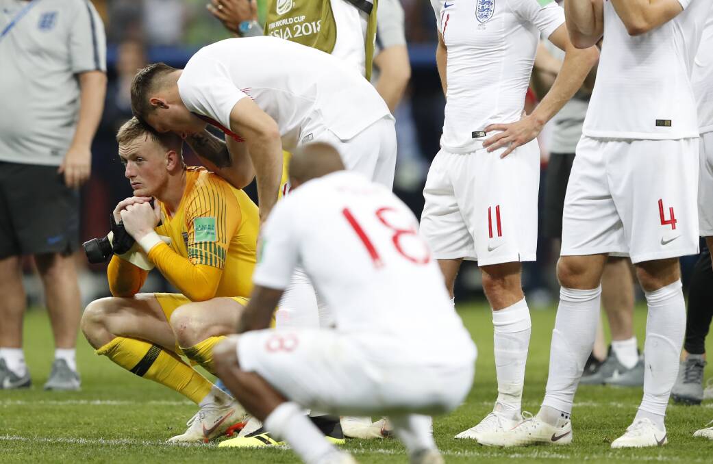 England goalkeeper Jordan Pickford, left, reacts at the end of the semifinal match between Croatia and England. Picture: AP 