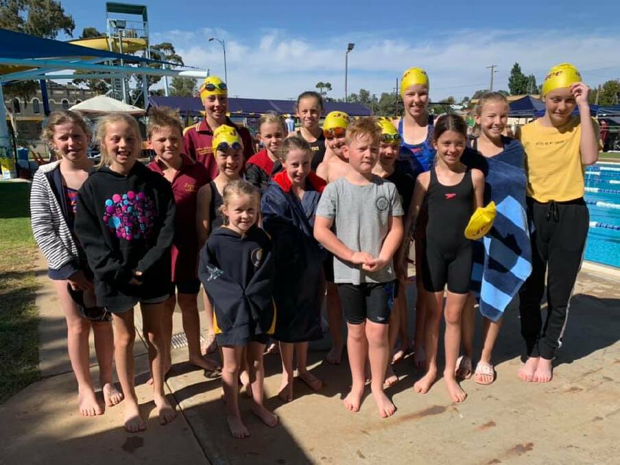 POOLSIDE: Junee Swimming Club members make the most of the sunshine at the carnival before a chilly afternoon. Picture: Contributed