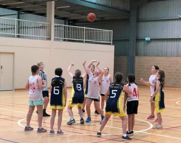 GAME ON: Junee's Under 12 girls take to the court, giving it their all for a solid team effort. Picture: Contributed