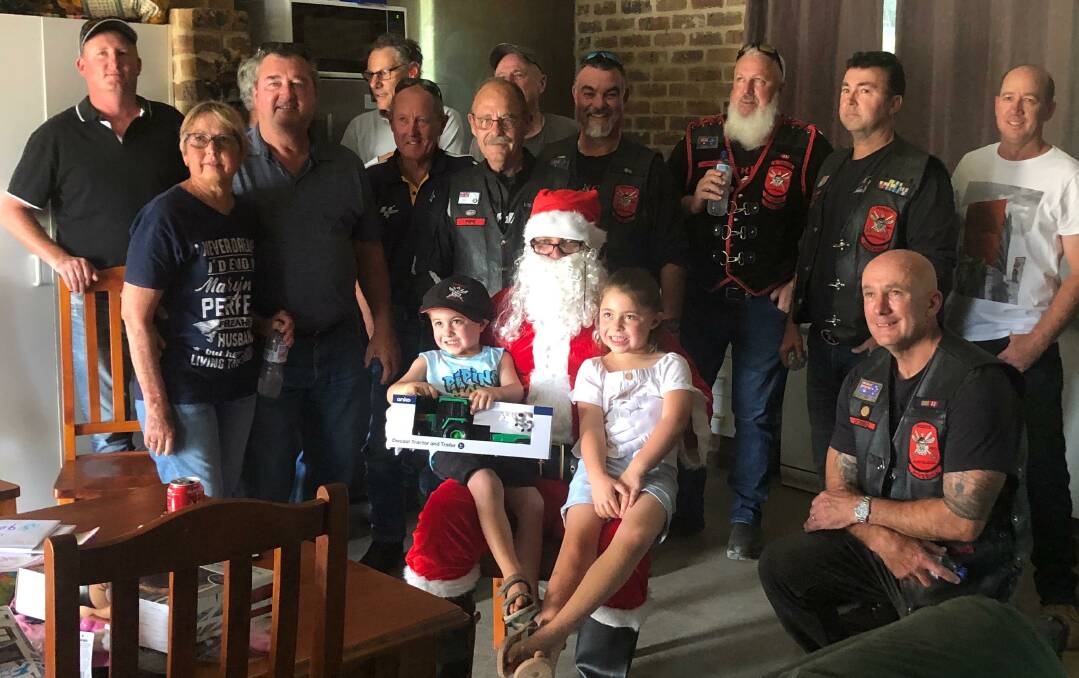SPECIAL GUEST: Little Cody and sister Bree get a special visit from the big man in red at their Nangus home as Christmas comes early. Picture: Contributed