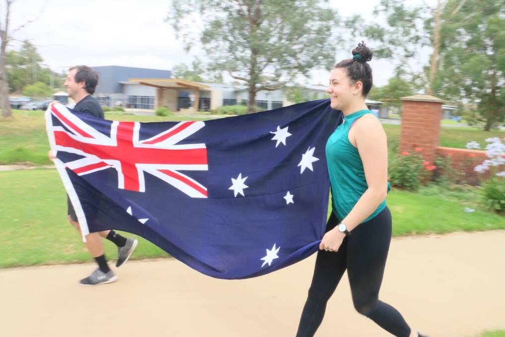 ON THE RUN: Ben Brown and Ruby Brodin show their Australian pride as they get in some training ahead of the big day. Picture: Jessica McLaughlin