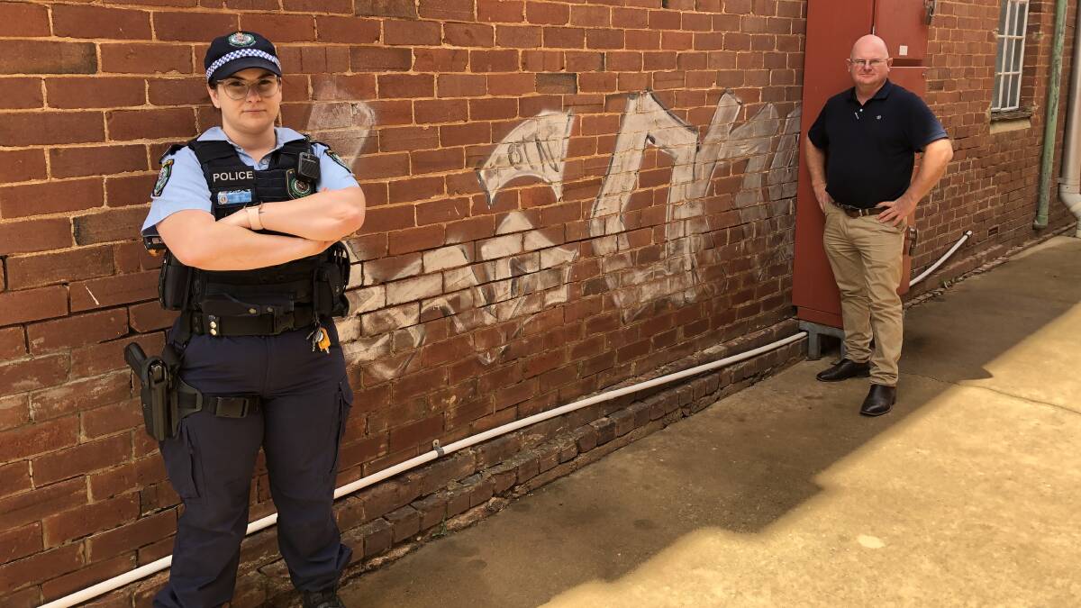 Rachel Doran and Glenn Sheehan with the graffiti. Picture: Contributed