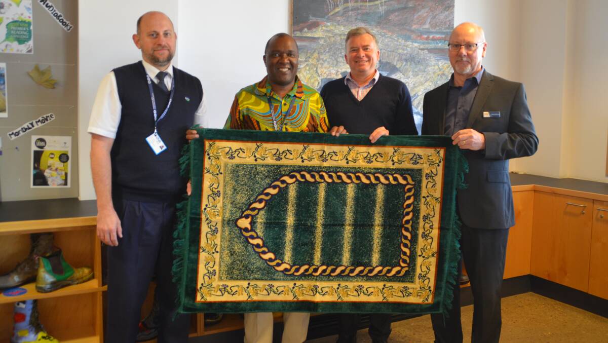 GENEROSITY: The prayer mat was accepted at the Junee Library by Rodney Garrett, Jericho Nyatoro, James Davis and Grant Johnson. Picture: Contributed