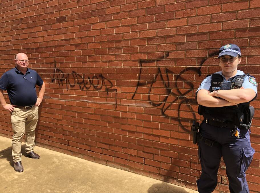 Glenn Sheehan and Rachel Doran with the graffiti. Picture: Contributed