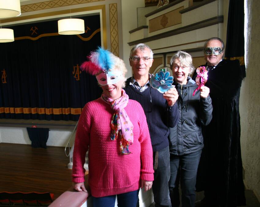 MASK UP: Virginia Stewart, George Benedyka, Carole Windsor and Lloyd Nesire model some masks ahead of the Athenium's masquerade ball. Picture: Declan Rurenga