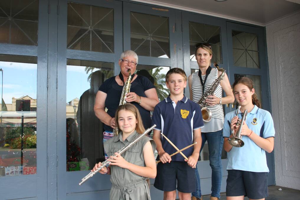 PLAY IT AGAIN: Junee Town Band members Jackie Starr (back, left), Alison Ashley (back, right), Tahlia White, Peter Guymer and Ineka Hart on the steps of the band's new home before its end of year concert on Sunday. Picture: Declan Rurenga